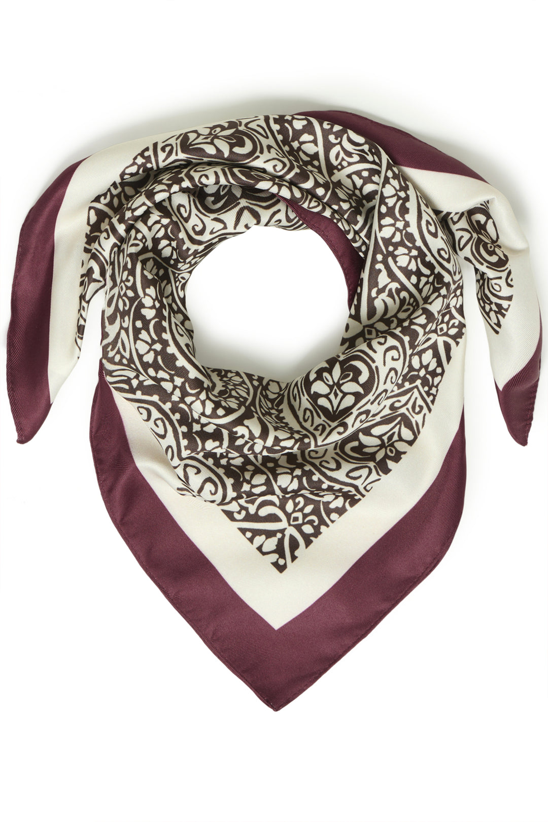 A square silk scarf with a burgundy and cream paisley pattern, styled in a loop to show its design and texture against a plain white background.