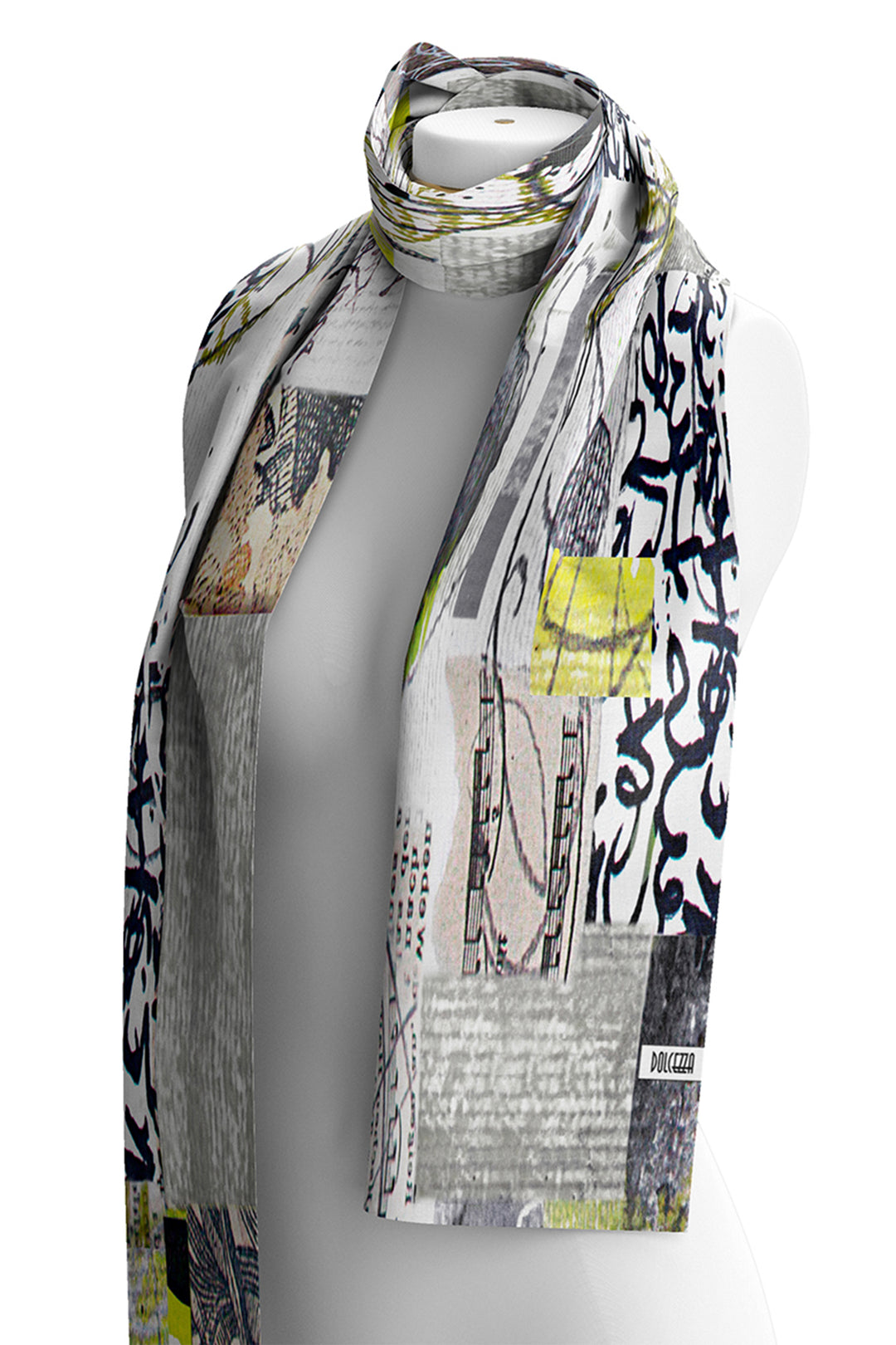 A long scarf with an abstract collage print featuring black graffiti-style lettering, gray textures, and bright yellow-green accents, displayed on a gray mannequin torso against a white background.