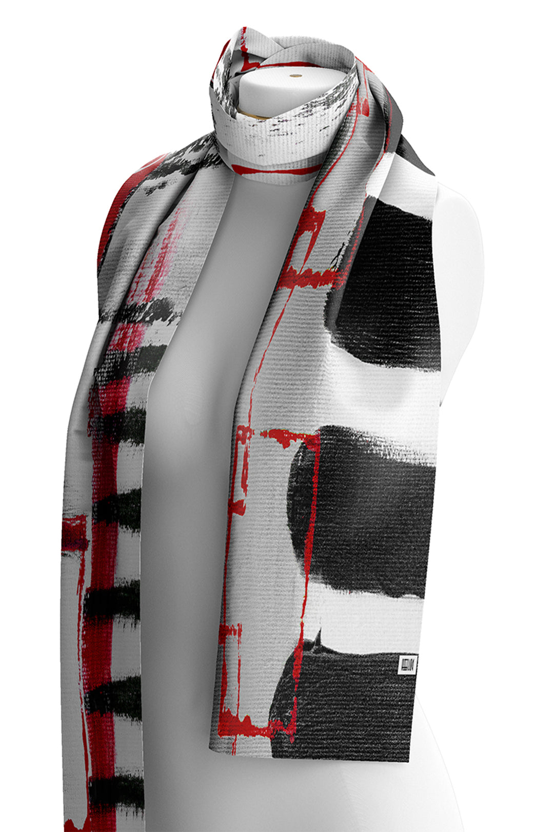 A long woven scarf with an abstract brushstroke pattern in black, white, and red, draped on a white mannequin torso against a white background.