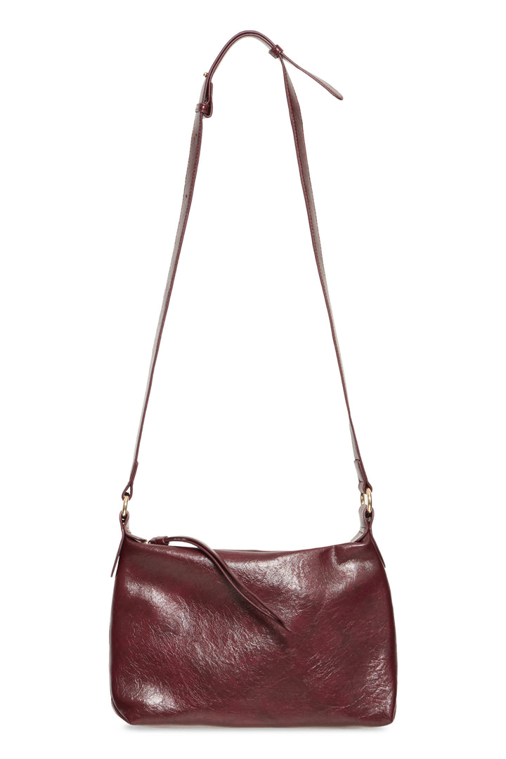 A dark burgundy leather shoulder bag with a long adjustable strap and gold-tone hardware, shown against a plain white background.