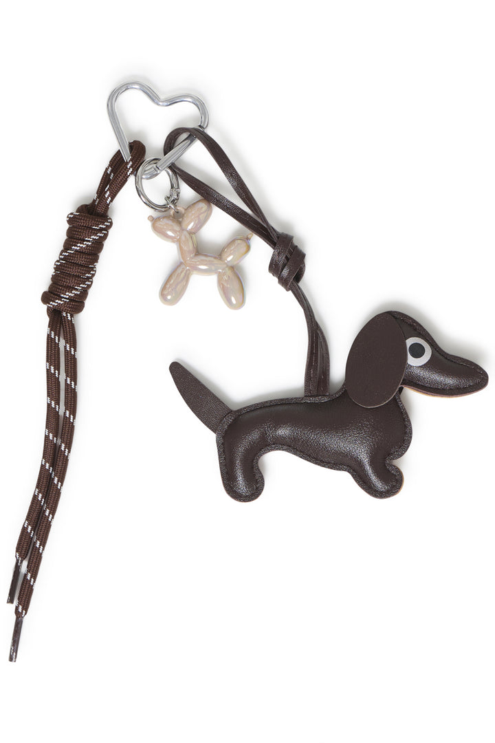 A brown dog bag charm shown against a white background. 
