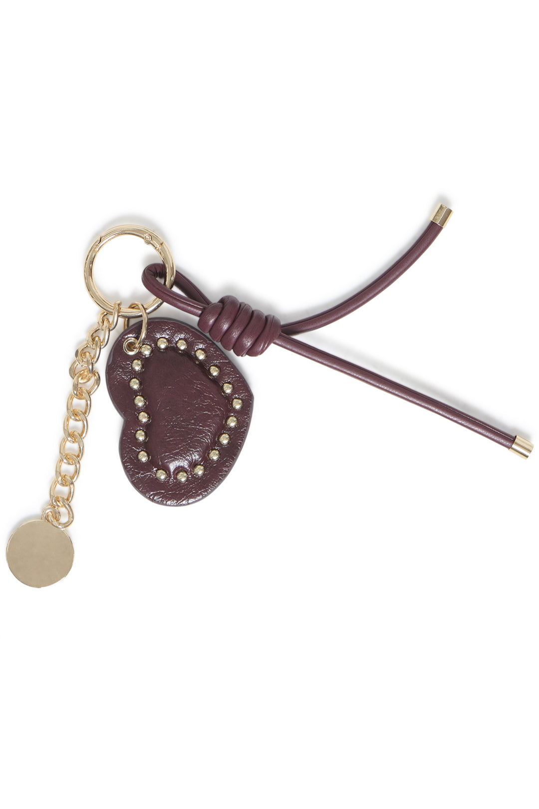 A brown heart bag charm shown in front of a white background. 