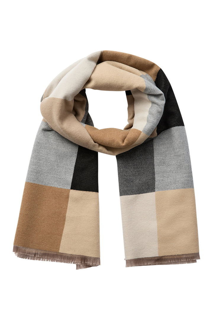 A bulky camel, beige, black square patterned scarf in front of a light grey background. 