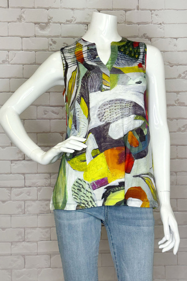 This light and loose top features a daring split collar and bold abstract artwork!