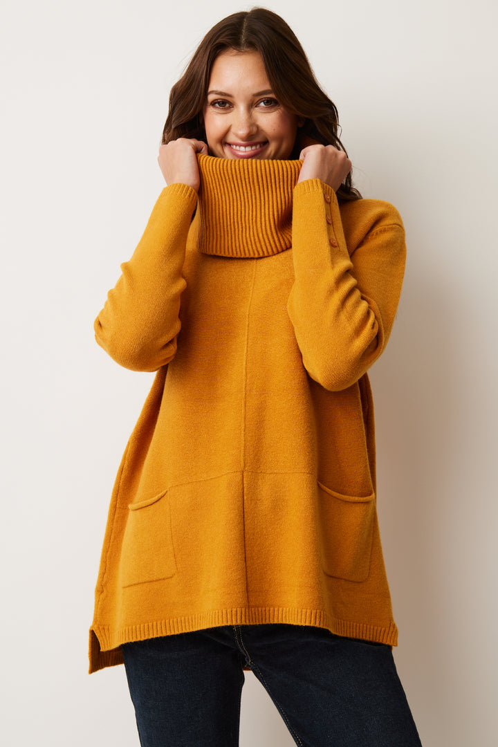 Its soft yarn fabric will keep you snug, while the removable turtleneck cowl collar and two front pocket detail add a touch of wonderful style. 