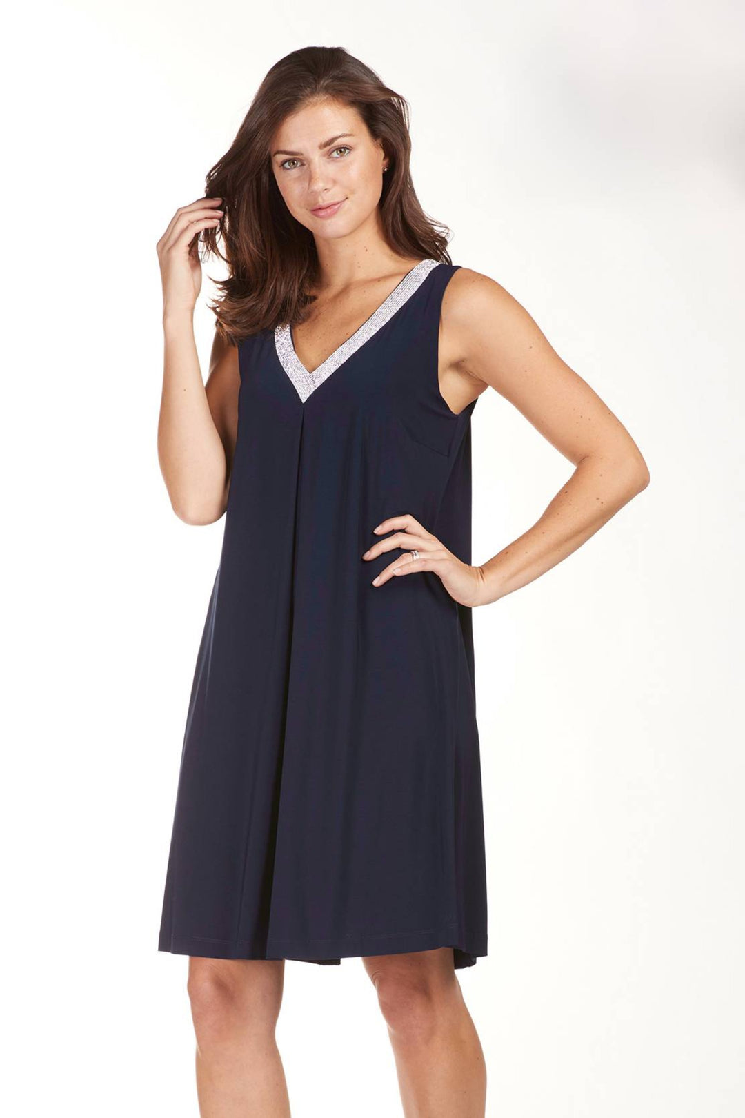 Frank Lyman Fall 2024 Adorned with diamond-like stones, the v-neck adds a touch of elegance to this sleeveless, fully lined lightweight cocktail dress. The flared style hem cut make it the perfect choice for a late afternoon out for drinks in an elegant setting. 