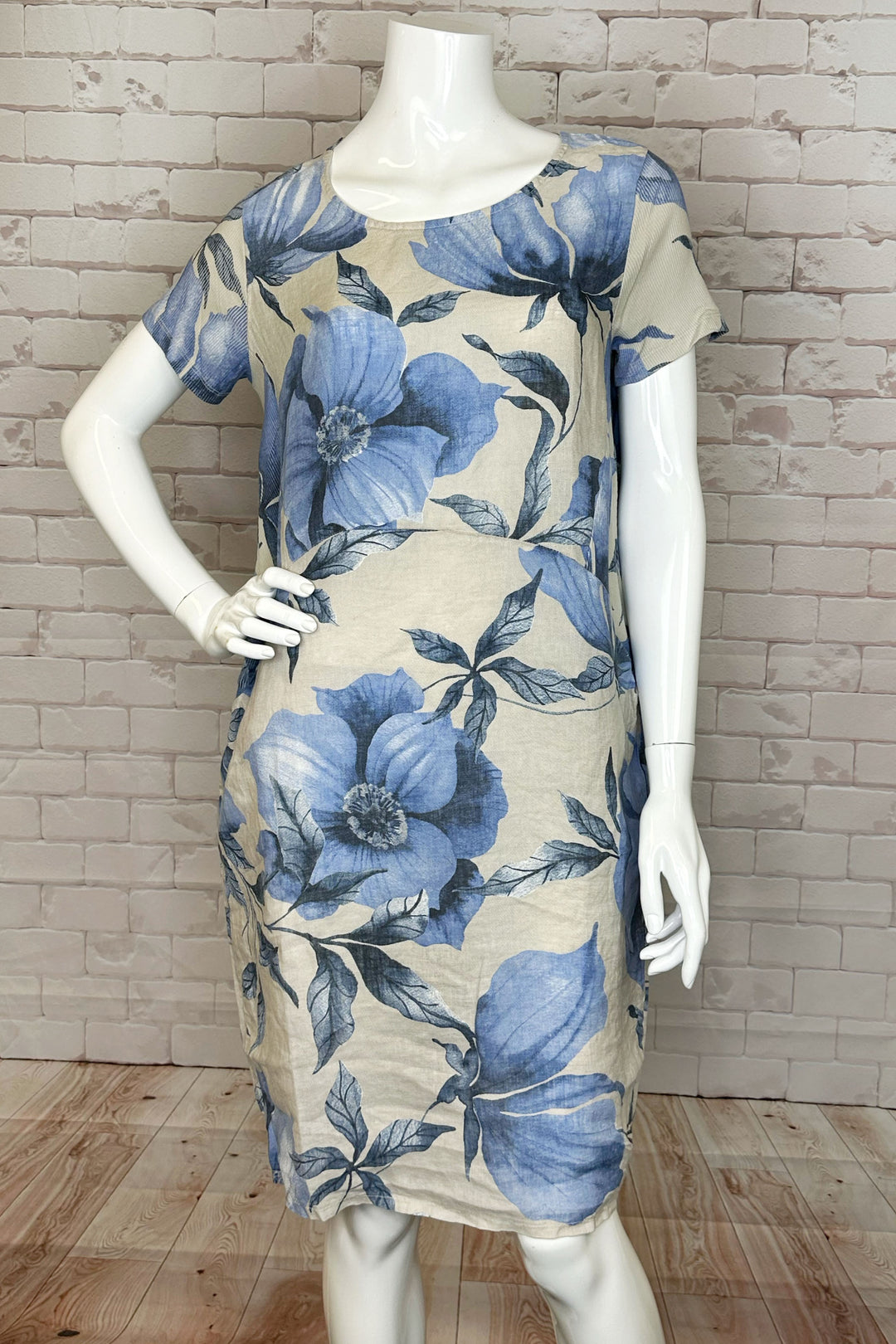 Featuring a lovely floral pattern and chic short sleeves with rib knit detailing, this dress is both fashionable and comfortable.