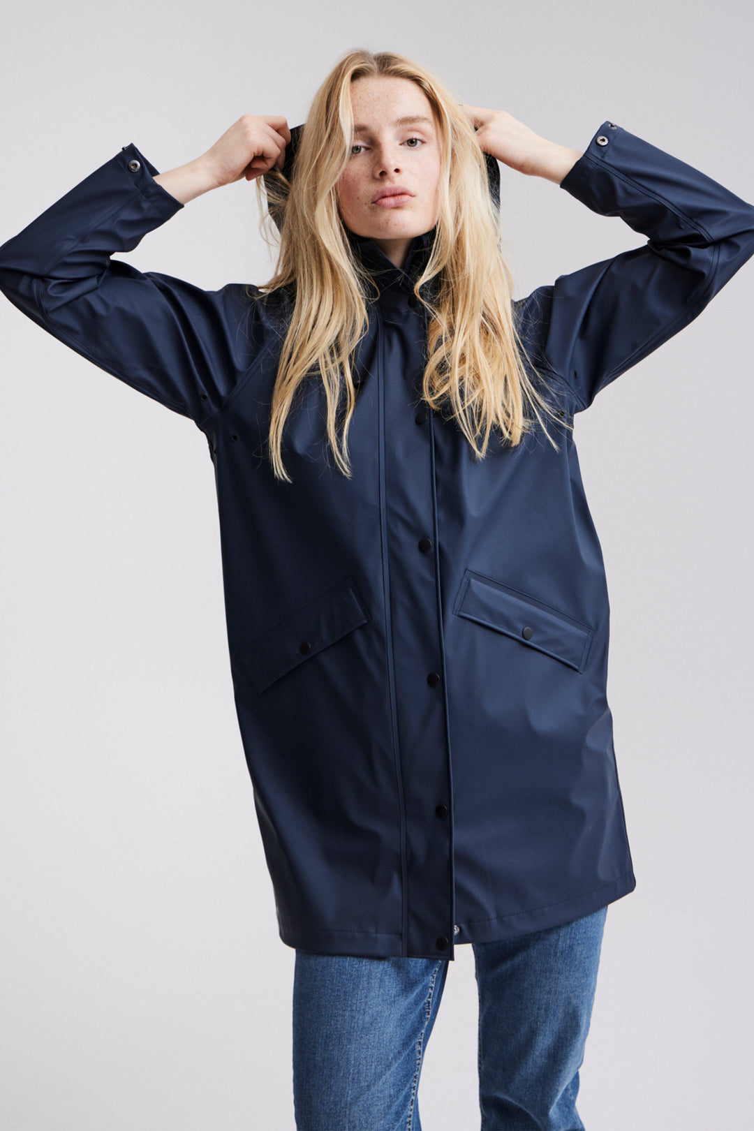 Crafted with a simple yet stylish design, the jacket features a hood, two front pockets, buttons and an above the knee length.