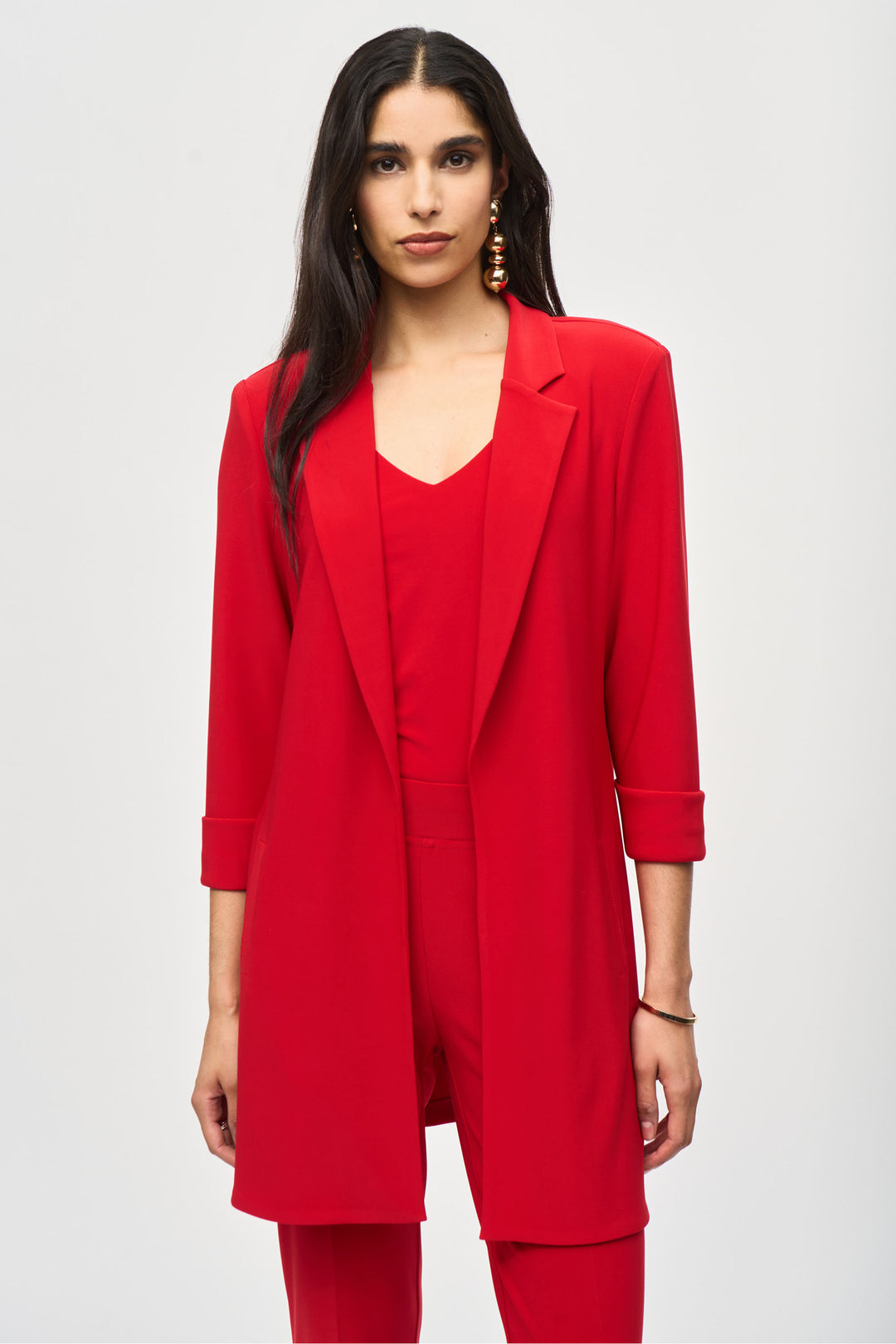 Joseph Ribkoff Fall 2024 It is made of eggshell woven fabric and features a notched collar, three-quarter length sleeves with cuffs, and a side slit.