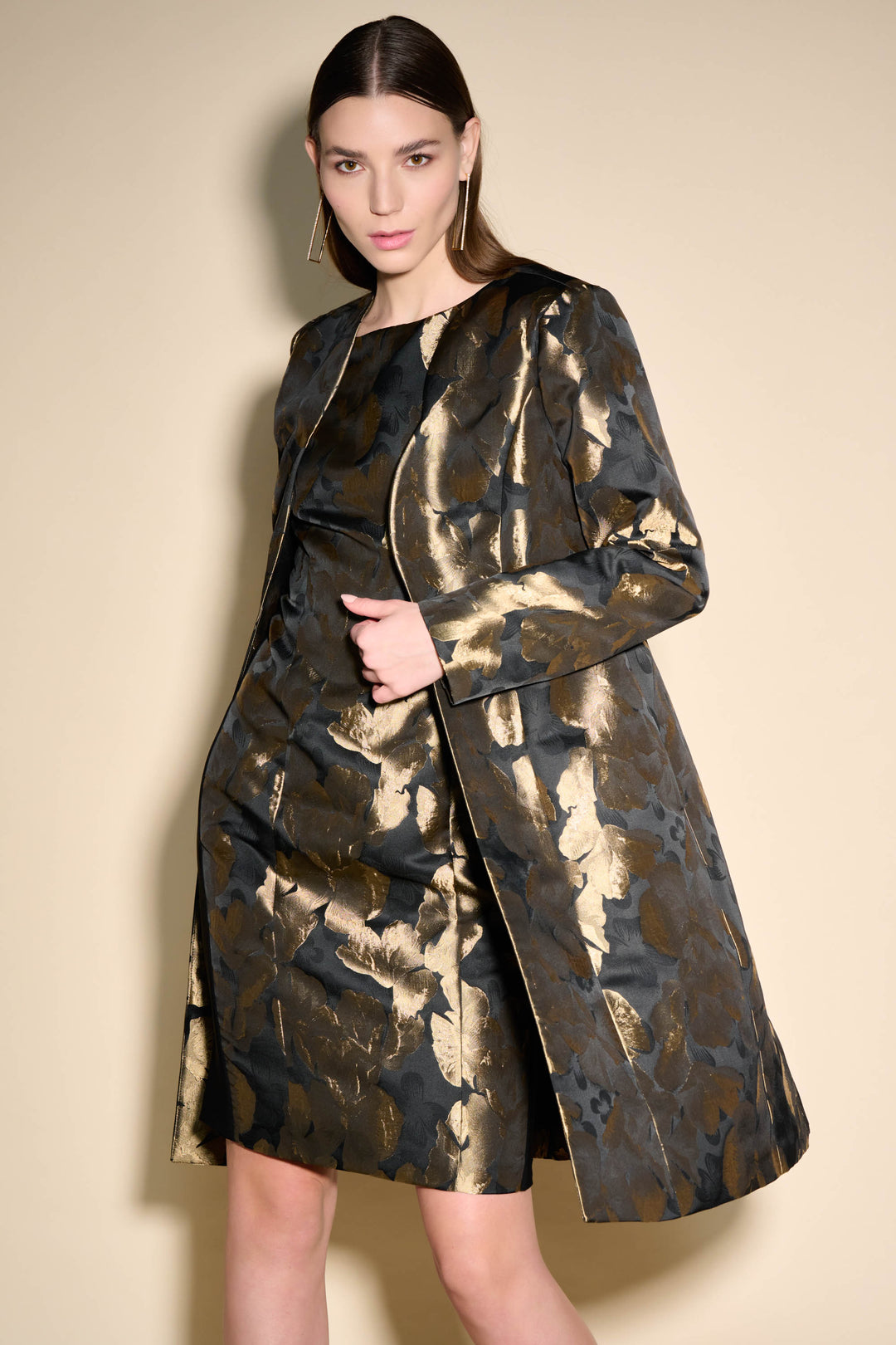 It features an open style light coat and an all-over foil leaf print that adds a glossy golden shine