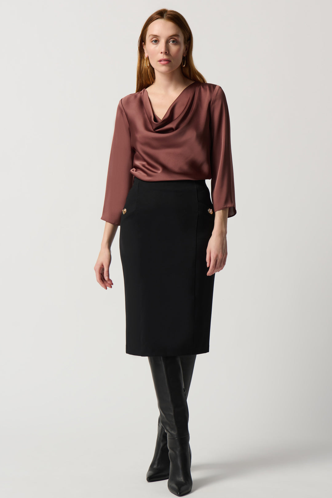 Featuring a concealed elastic waistband, two front pockets with ornamental turn-locks, knit fabric and length below the knees, you’ll look professional and feel secure. 
