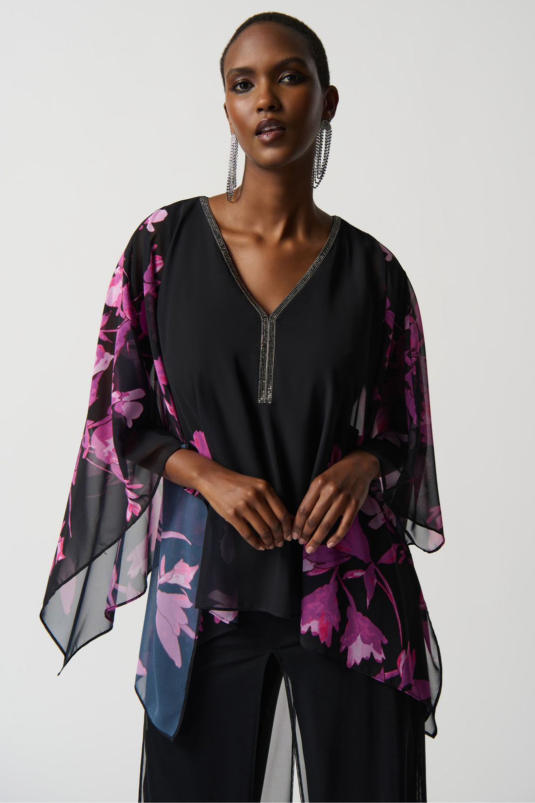 Glistening studs along the v-neck line bring a sparkle to the evening while the poncho style and loose fit keep you comfortable and stylish.
