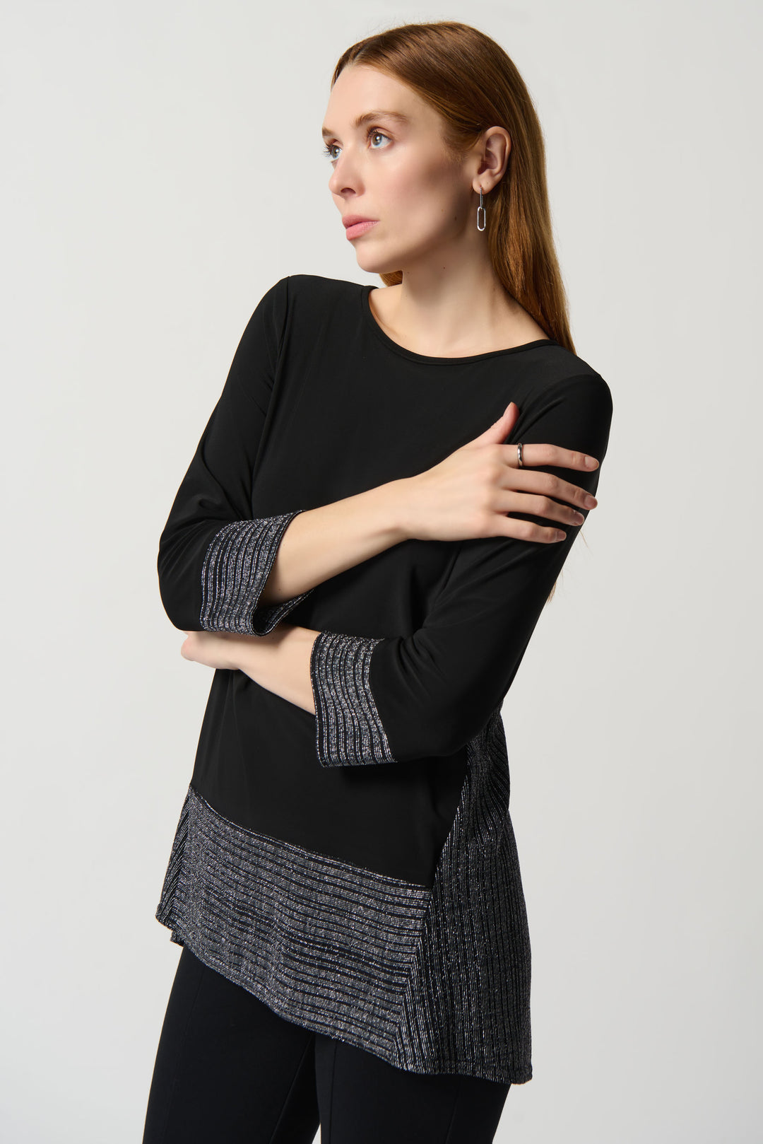 Its 3/4 length sleeves and loose fit provide an effortless feel, while its shimmering details on the cuffs and lower portion give a hint of luxury. 
