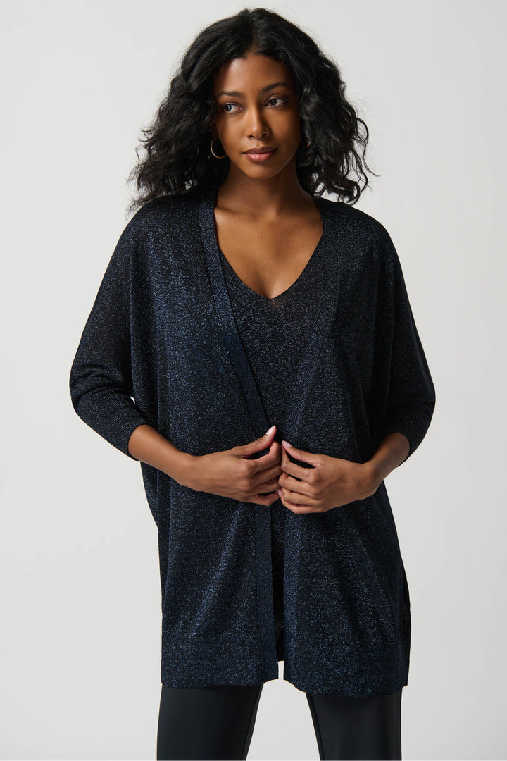The stylish metallic knit top features dolman sleeves and a v-neck for a stunning look. 