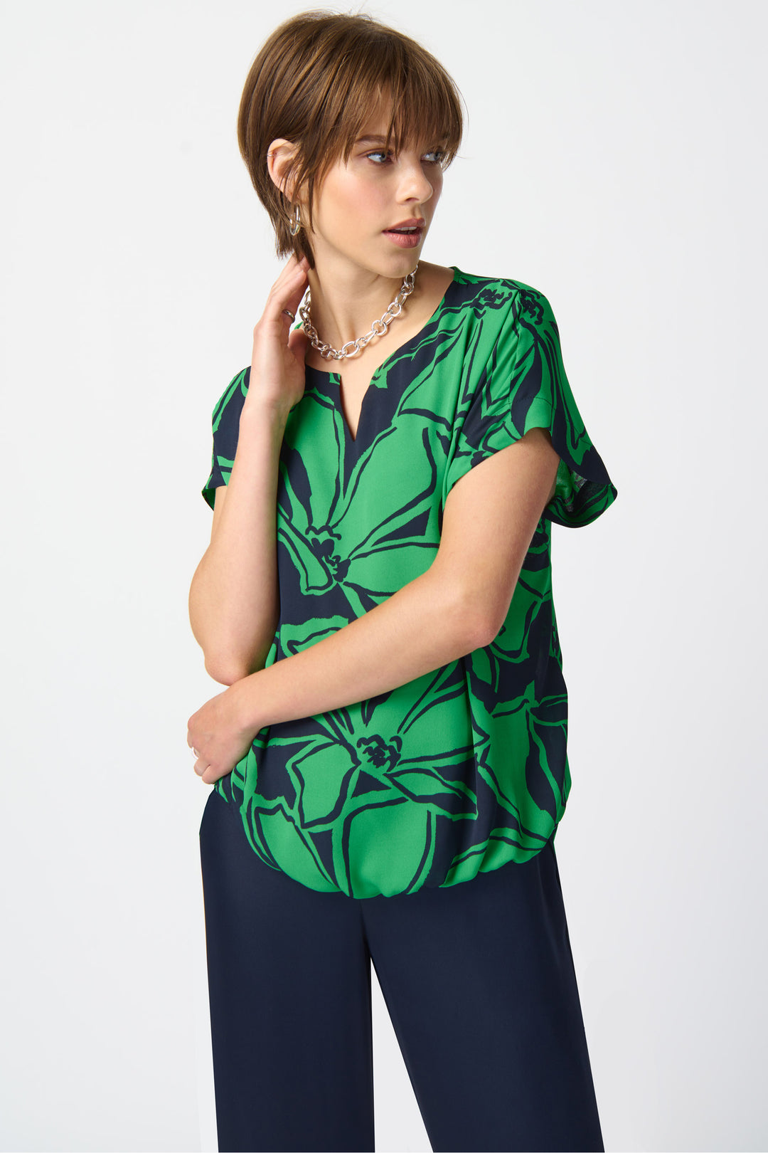 The round neckline is split, adding a unique detail to this chic top.