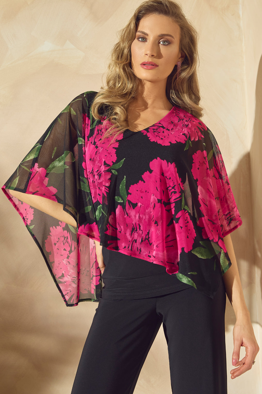 Frank Lyman Spring 2024 With a lovely floral print that adds a touch of romance, the chiffon overlay drapes beautifully in a poncho style. 
