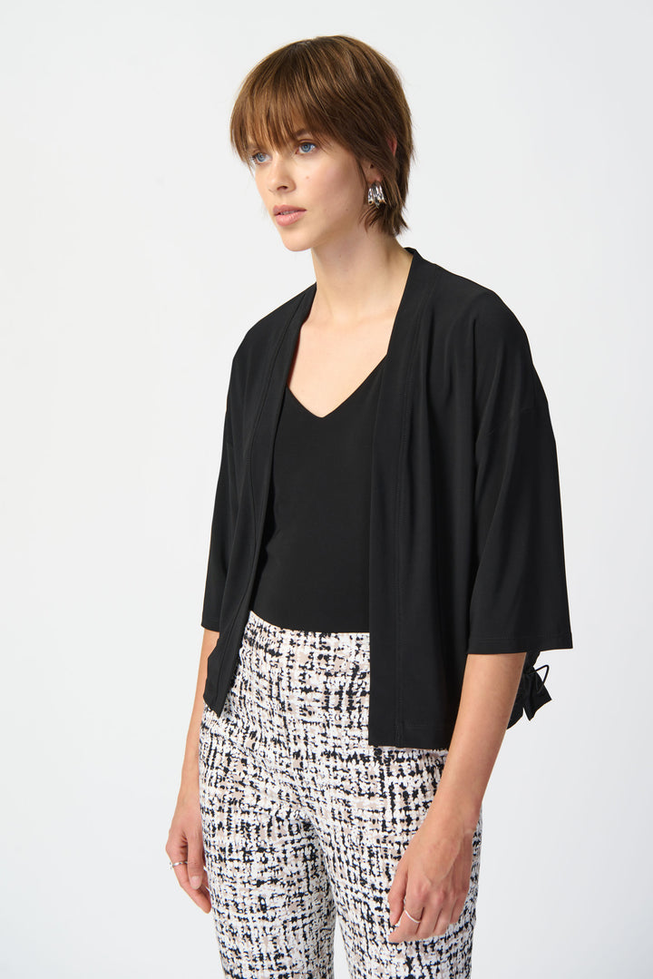 This cropped open cardigan doubles as a top and features a sleek, contrasting memory fabric back for a modern twist.