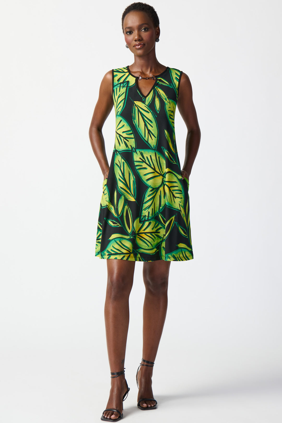Featuring a tropical flare and a chic pointed neckline adorned with a metal chain, this dress will make you stand out!