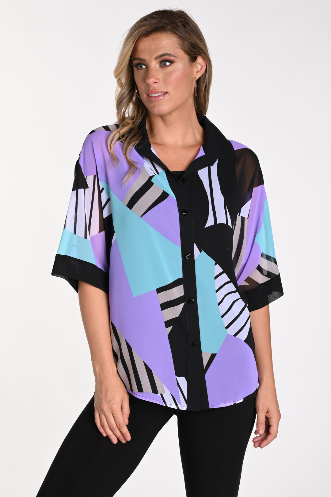 Frank Lyman Summer 2024 Made with woven fabric and relaxed, loose half sleeves, its standout feature is the neat, vibrant abstract print all-over. 