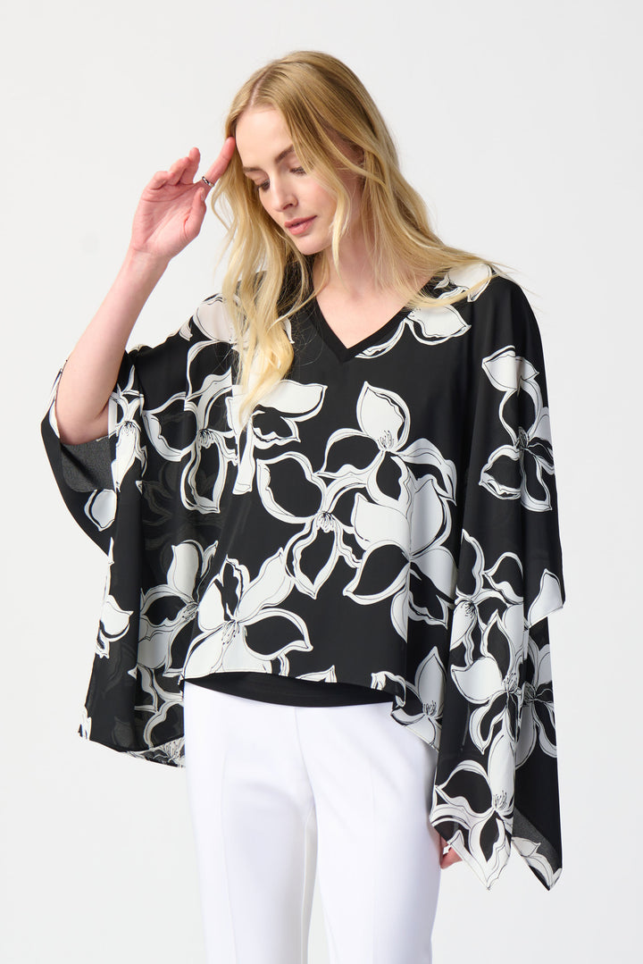The soft cut v-neck adds a touch of elegance while the loose, flowing poncho design provides comfort and style. 