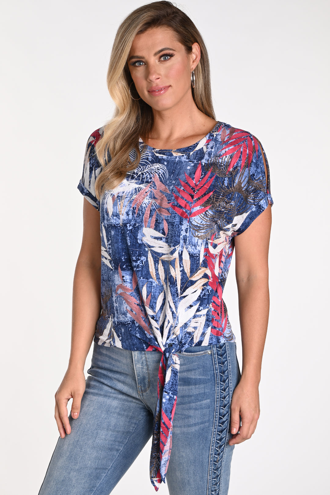 Frank Lyman Spring 2024 The tie knot detail at the front and the slit cut short sleeves adds a trendy touch to the tropical floral pattern.