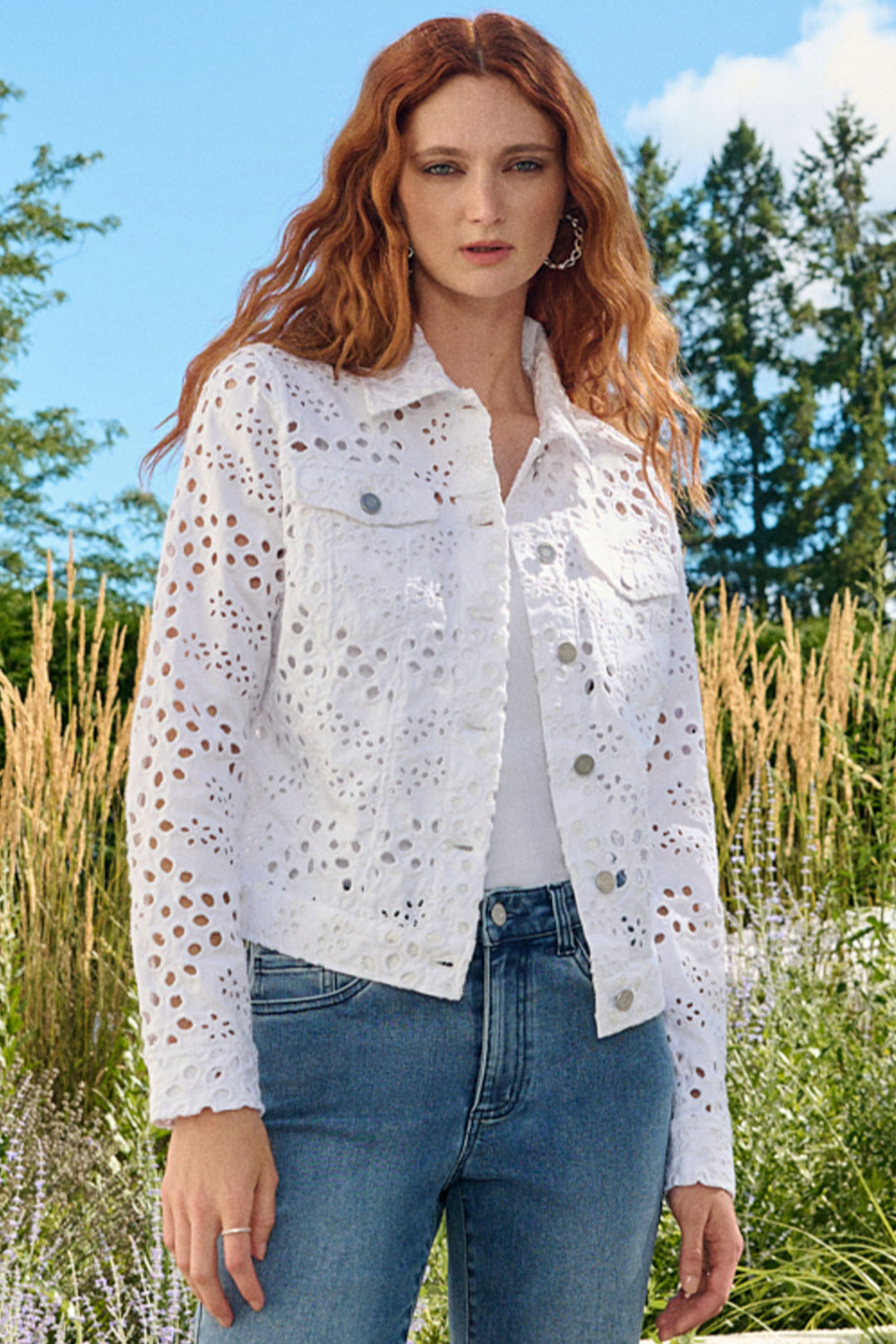 The pierced eylet pattern adds a unique touch and the classic collar and full length sleeves provide a timeless look.