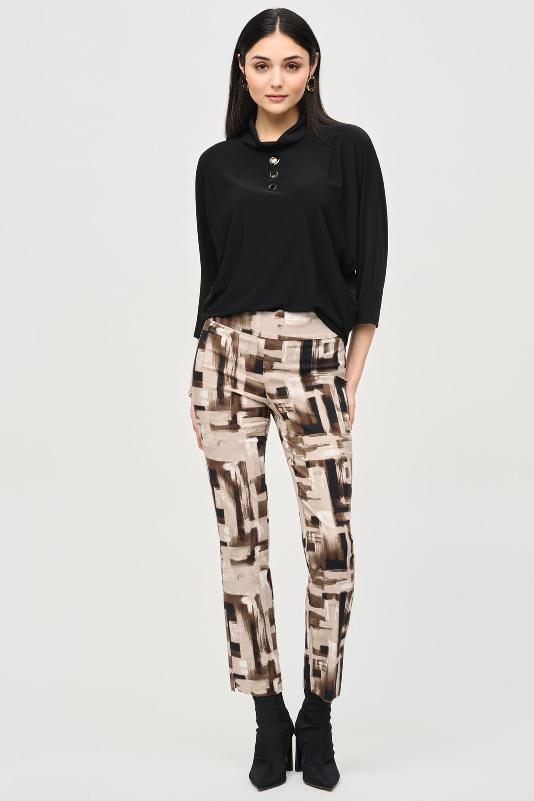 Joseph Ribkoff Fall 2024 These fun pants feature an all-over abstract print with square pattern and the pull-on waistband, slim legs with front seams creates a slimming effect. 