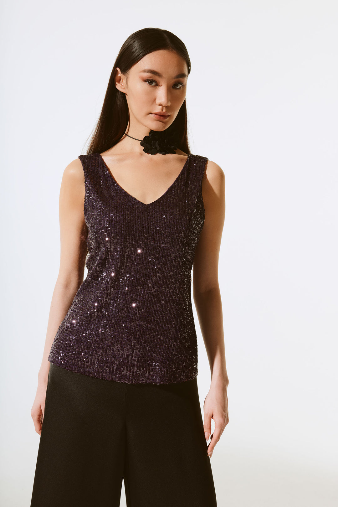 Joseph Ribkoff Fall 2024 This sleeveless top by Joseph Ribkoff is a must-have for a special event! Your look is sure to catch the eye with the shimmer of sequin fabric and the high-quality construction of the v- neck, sleeveless style.
