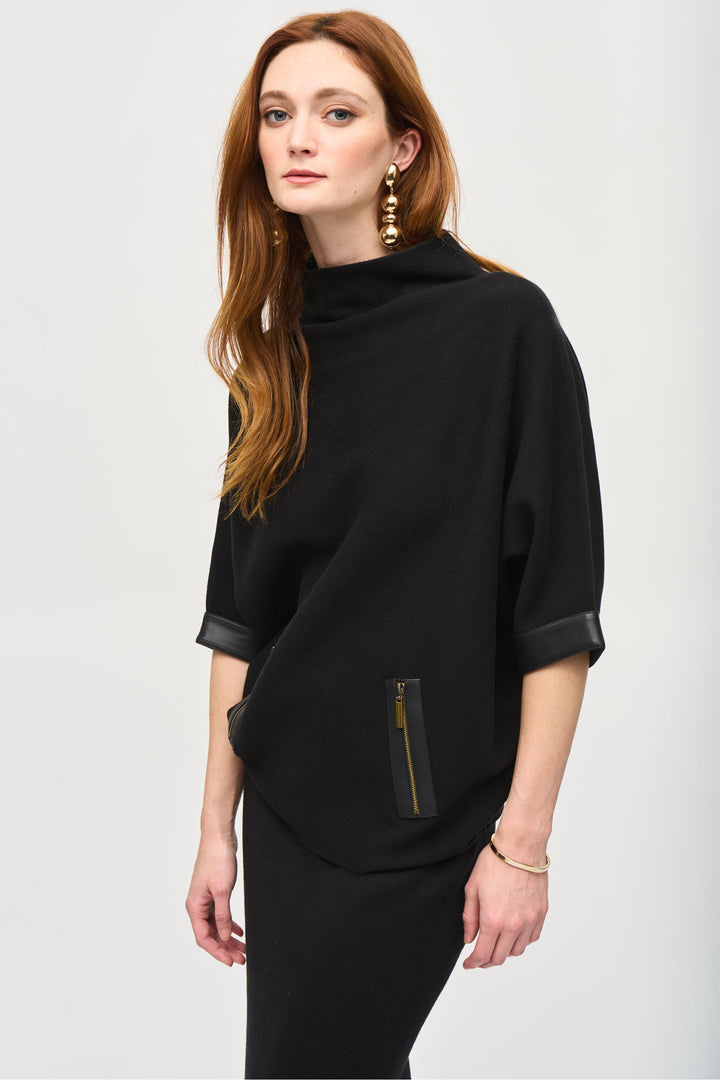 Joseph Ribkoff Fall 2024  Featuring sleek leather trim on the cuffs, this fancy sweater top is perfect for cooler weather. The 3/4 length dolman sleeves and funnel neck add a touch of elegance, while faux zipper pockets provide a stylish finish. 