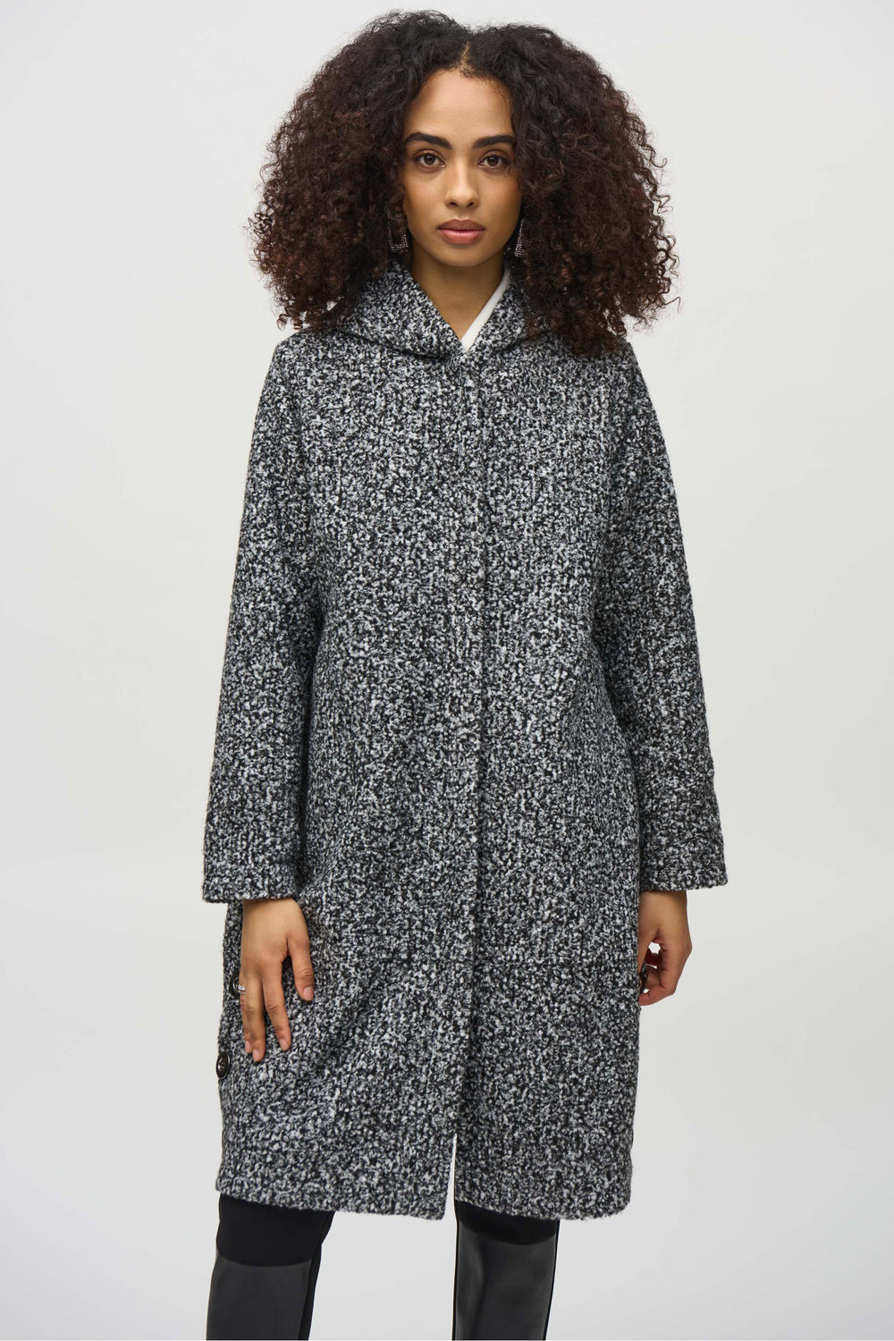 Joseph Ribkoff Fall 2024  Crafted from boucle knit fabric, this coat boasts a stylish hoodie and button closure. Perfect for the fall and winter seasons, it also features convenient side pockets for added functionality. 