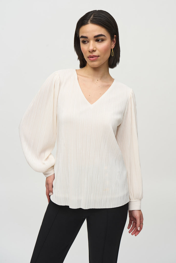 Joseph Ribkoff Fall 2024 The long loose sleeves and pleated design pattern make it versatile, perfect for dressing up or keeping it casual.