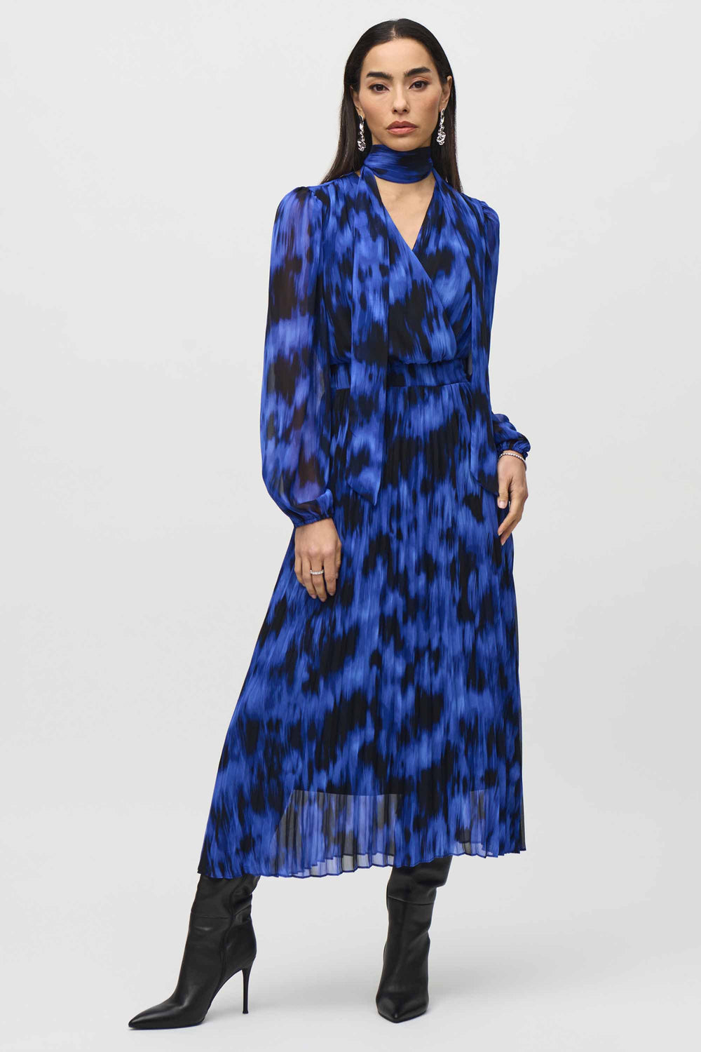 Joseph Ribkoff Fall 2024  The pleated skirt, wrap v-neck and full length puffy sleeves create a figure-flattering silhouette that will turn heads! 