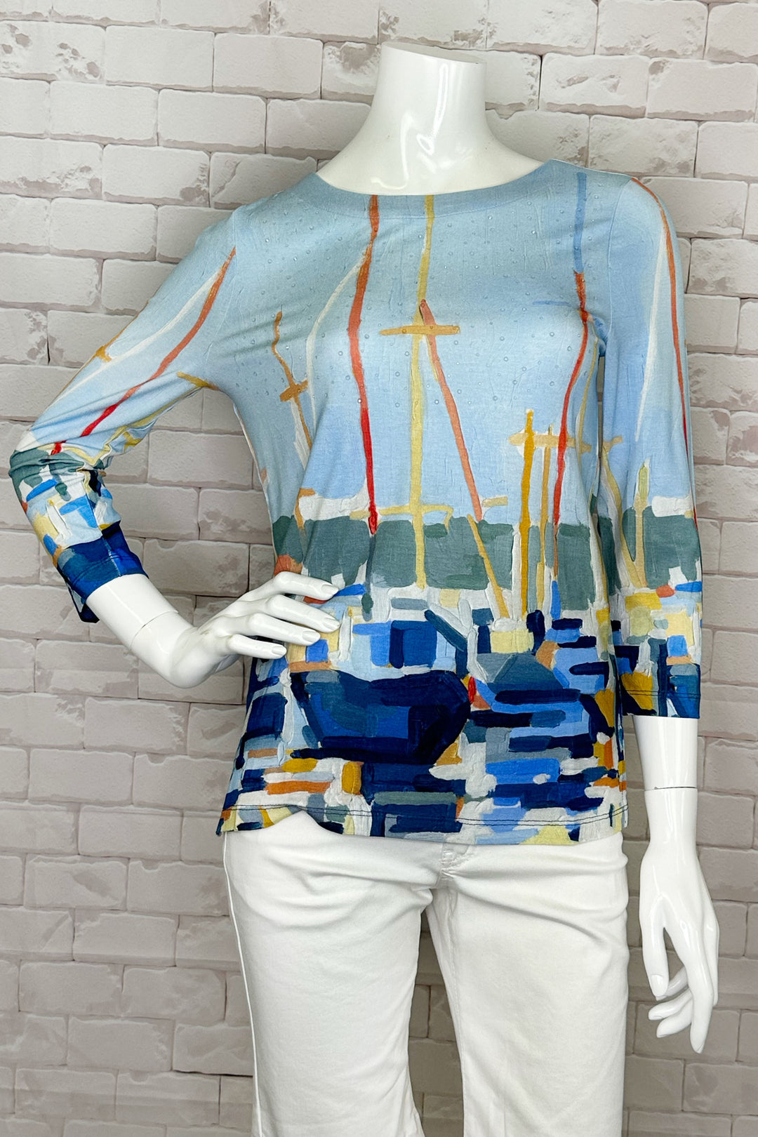 Dolcezza Spring 2024 Featuring a round neckline and 3/4 length sleeves, this top is adorned with clear rhinestone details and an all-over marina print designed by US artist Emma Caroline.