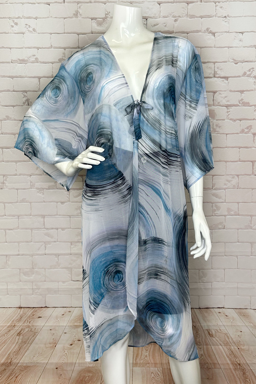 Dolcezza Spring 2024 With its lovely tie knot front, loose drape half sleeves and high low hem, this cover up is perfect for a relaxed and stylish look. 