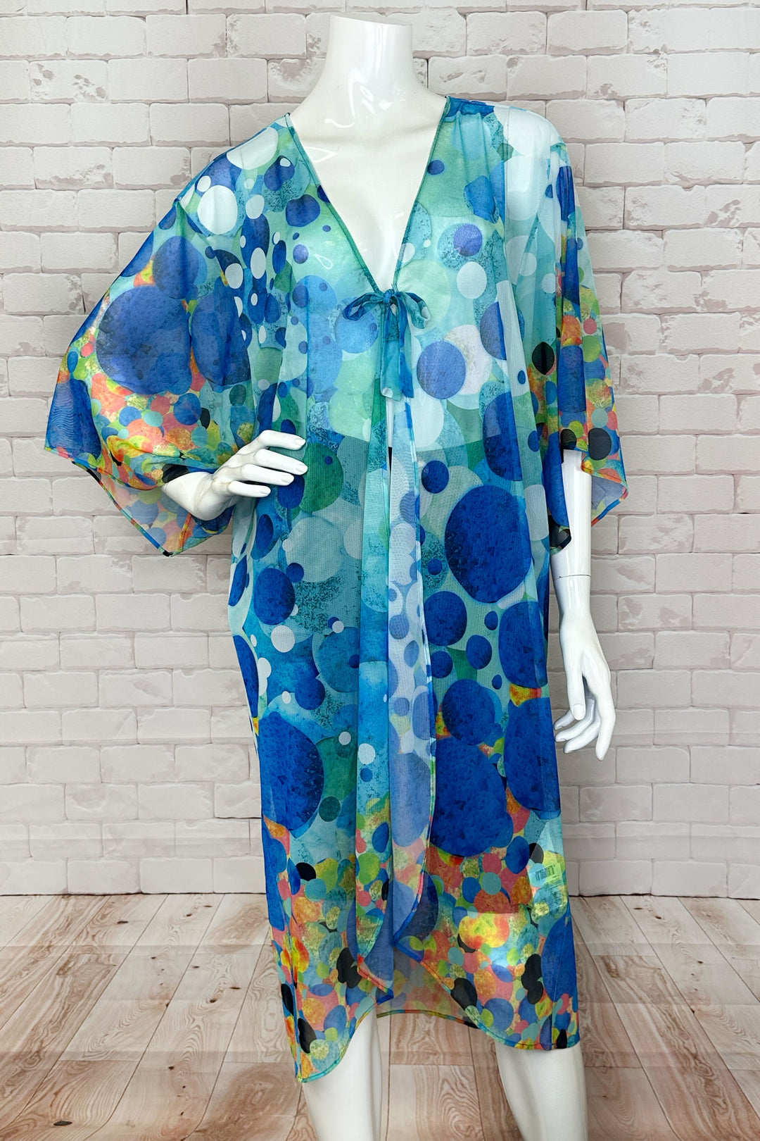 Dolcezza Spring 2024 With its lovely tie knot front, loose drape half sleeves and high low hem, this cover up beachwear is perfect for a relaxed and stylish look.