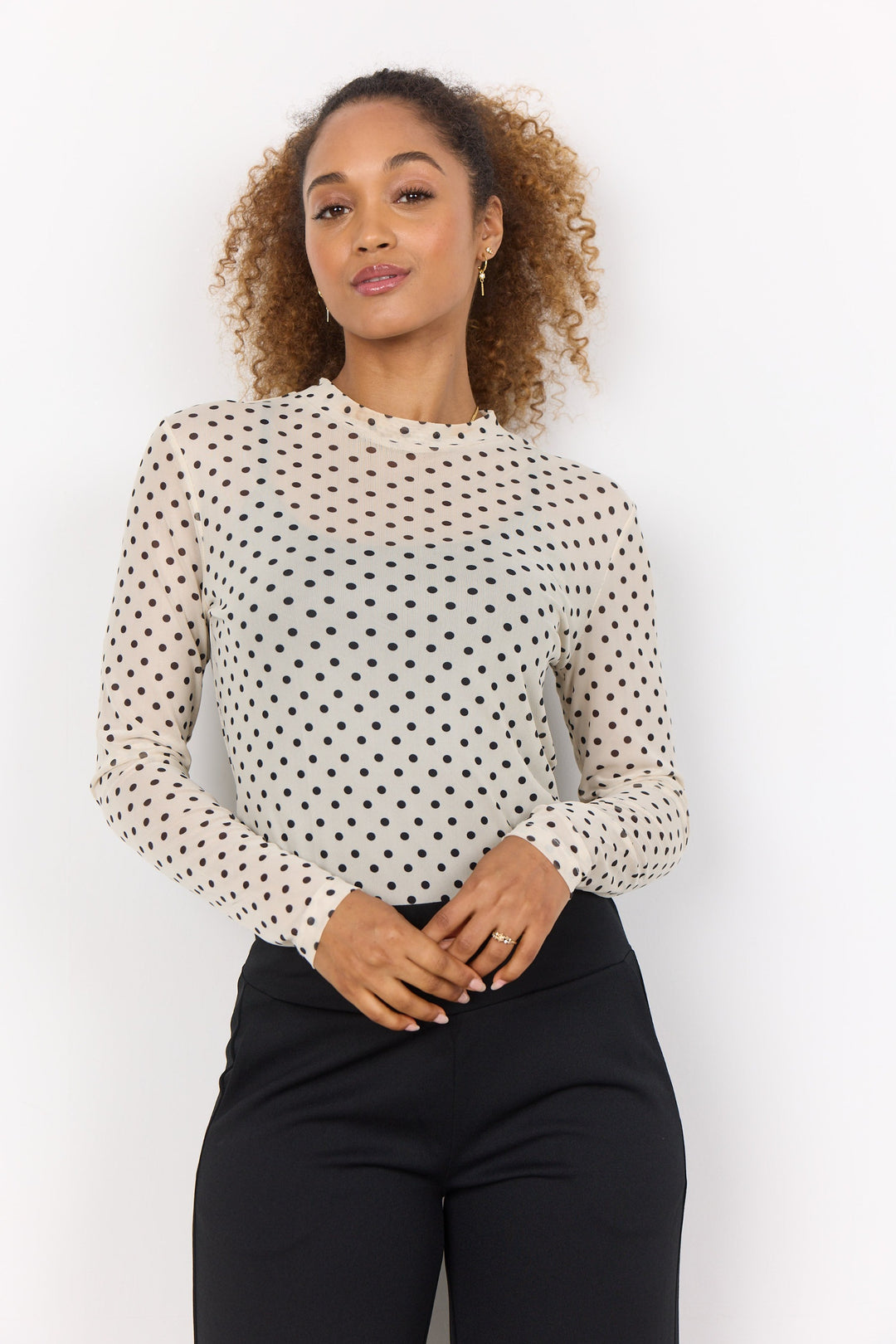 Soya Concept Fall 2024 Made from neat mesh fabric, this top features a lively polka dot pattern and a high neck design with long sleeves.