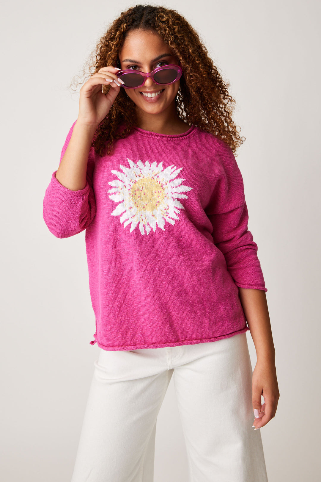 So standout with a rolled hem, 3/4 length rolled sleeves with a slight boat neckline with a cheerful flower embroidered into the sweater.  