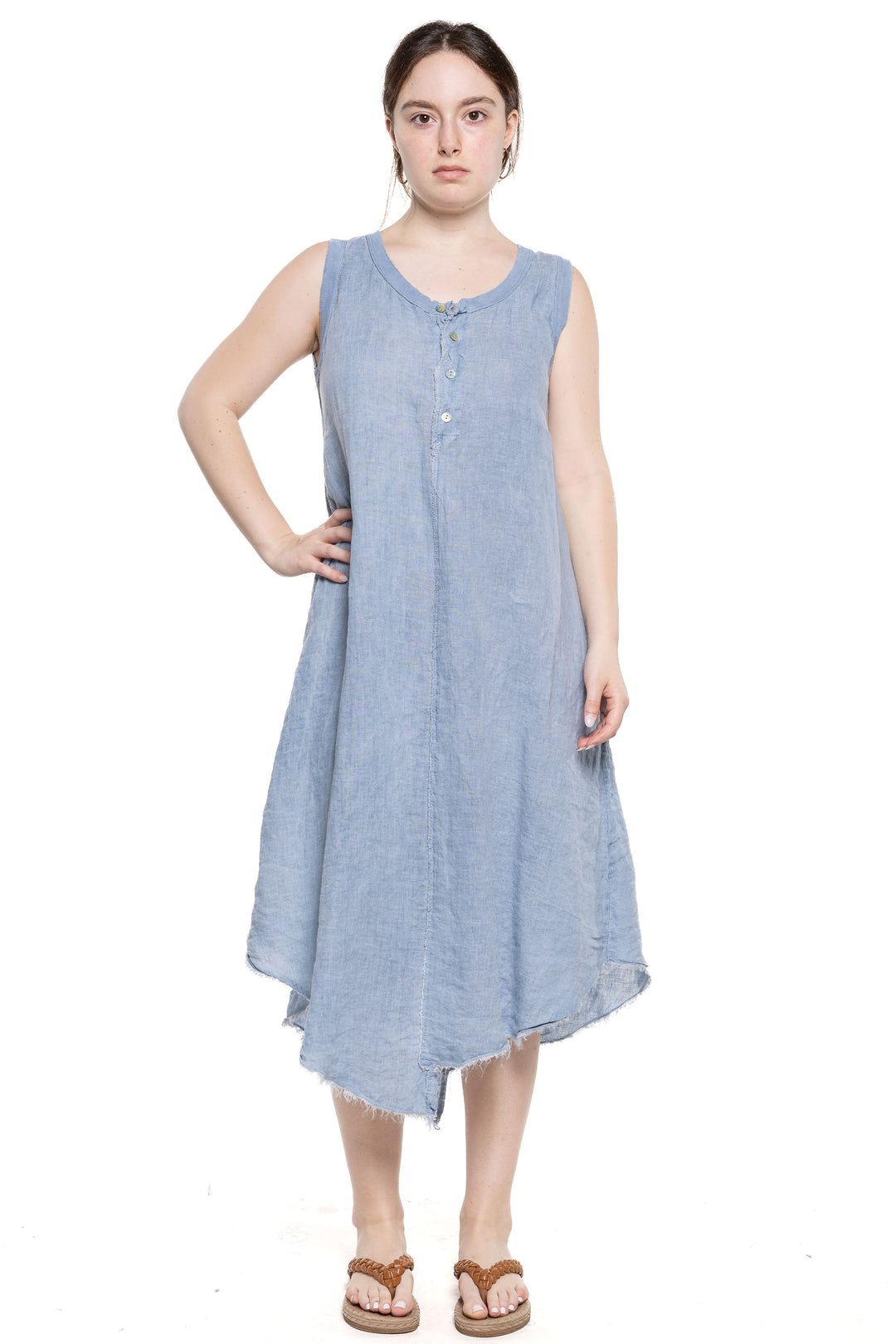 Etern Elle Summer 2024 This midi dress features a fitted bust and a flared bottom with an uneven cut hem. The lightweight and sleeveless design makes it perfect for warm weather.