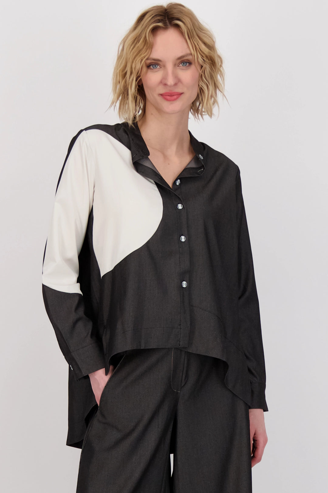 Crafted with silky smooth fabrics and featuring full length sleeves, this blouse is designed with a unique abstract pattern and finished with front buttons.