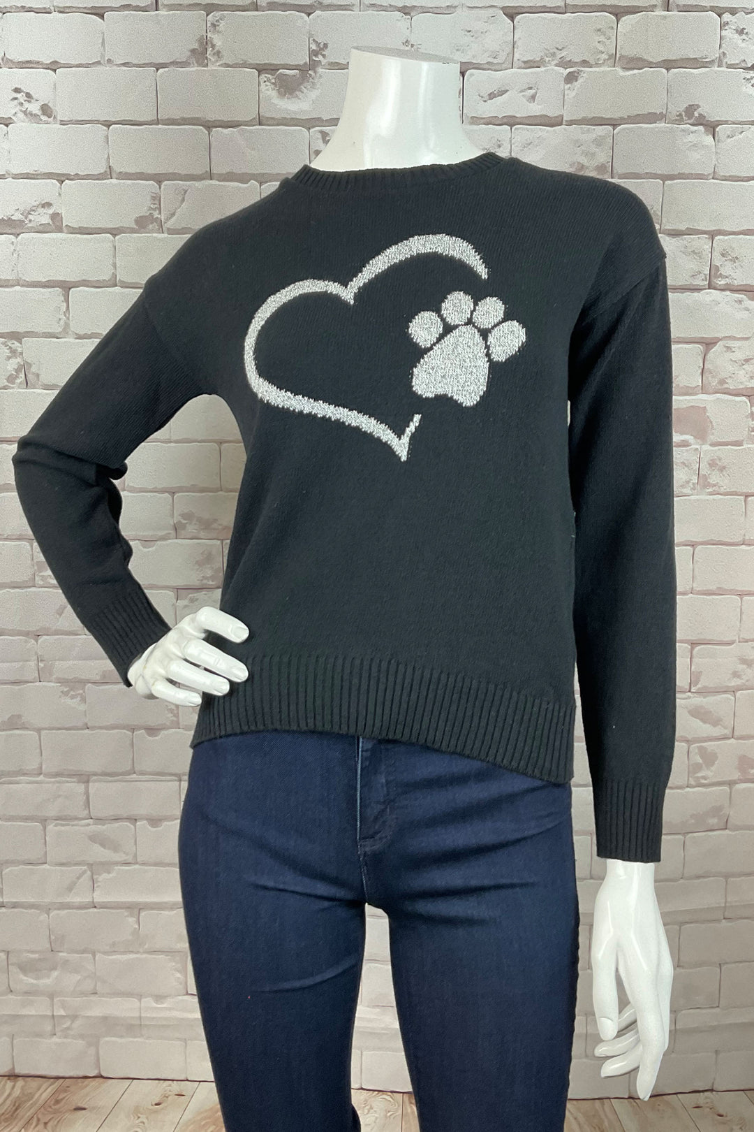 Cotton Country F24  Made from soft, cozy cotton, this knit sweater features a cute heart and paw design, perfect for animal lovers! The ribbed cuffs, hem, and neckline add a touch of classic charm to this playful piece.