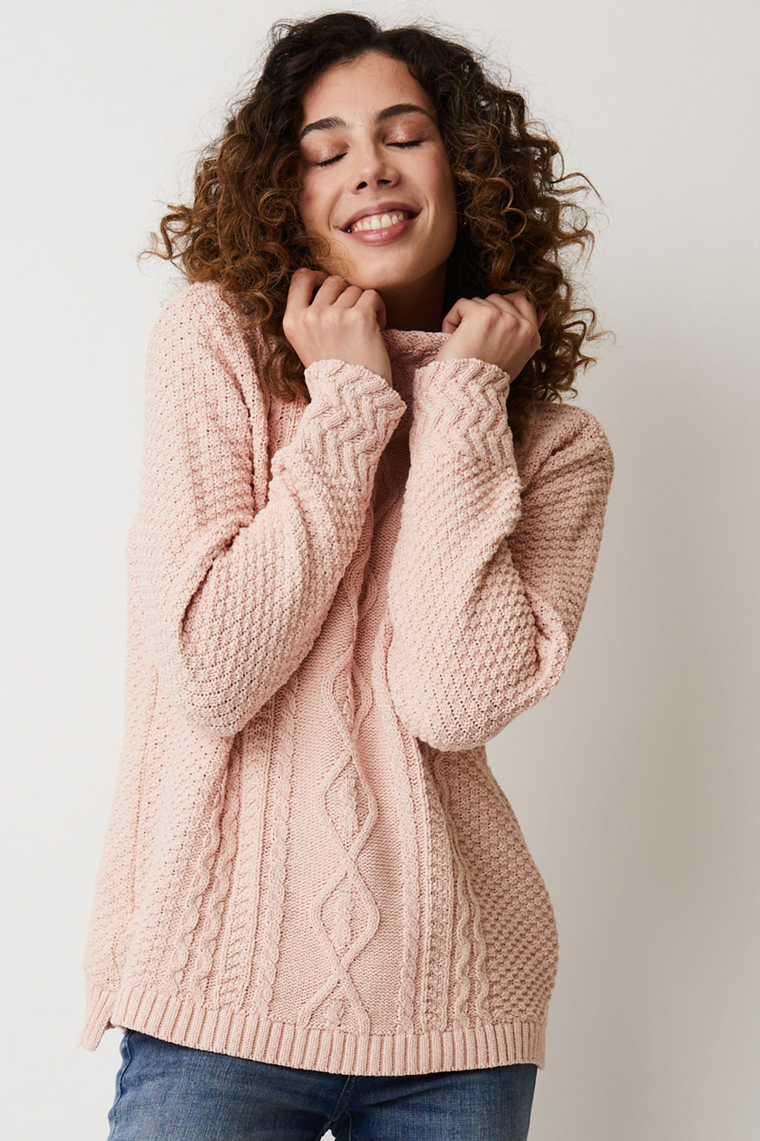 Its funnel neckline and long sleeves are intricately designed with cable knit for added elegance and warmth.