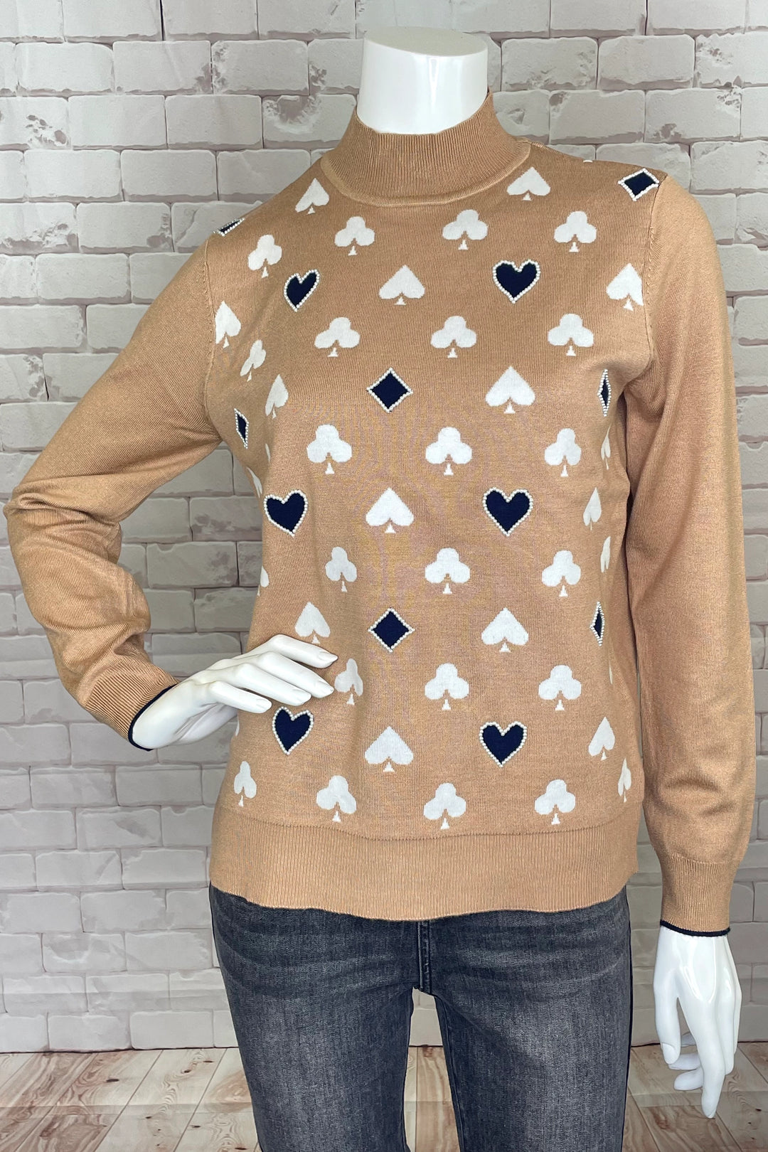 This mock neck long sleeve style features a bright and bold deck of card suits design, sure to let you stand out from the crowd! 