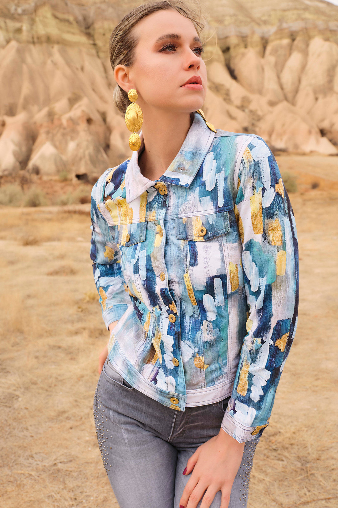 This abstract with blue design all-over print offers two faux breast pockets, button cuffs and golden front buttons with a classic collar.