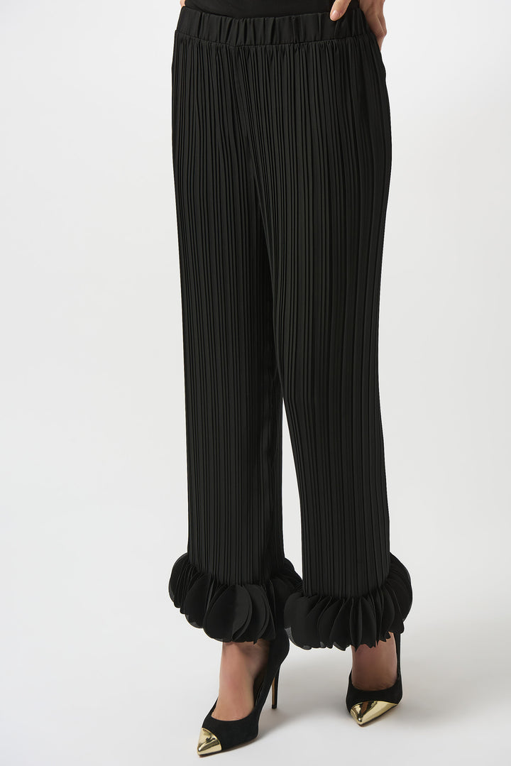 Joseph Ribkoff Fall 2025 
These black pleated pants feature delicate ruffled details and distinctive circle accents along the hems, lending a refined and elegant touch. The elastic waist ensures a comfortable yet flattering fit, while the flowing, lightweight fabric offers effortless movement.