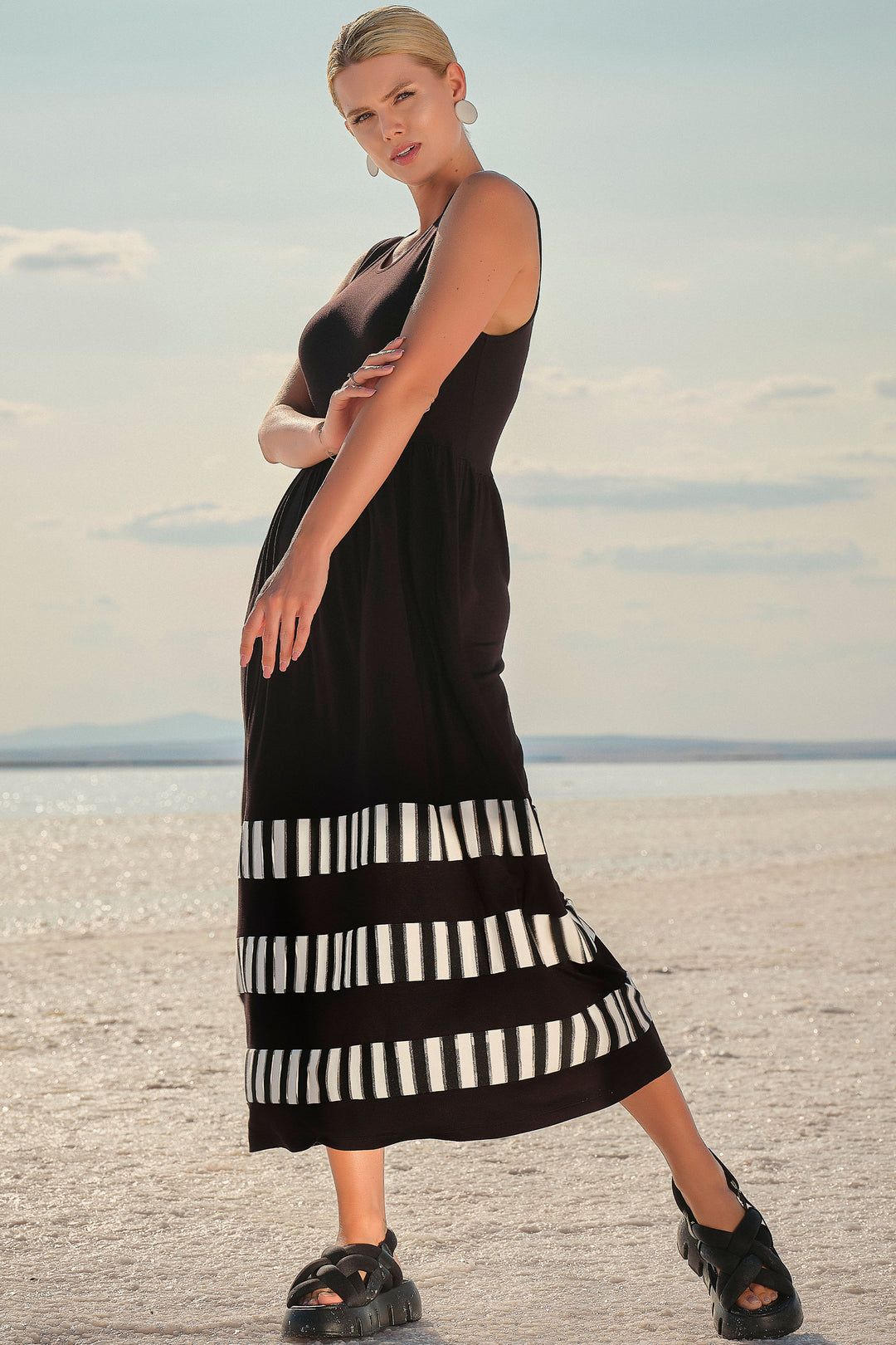 Ever Sassy Spring 2024 This chic dress features a round neckline, sleeveless and maxi length.