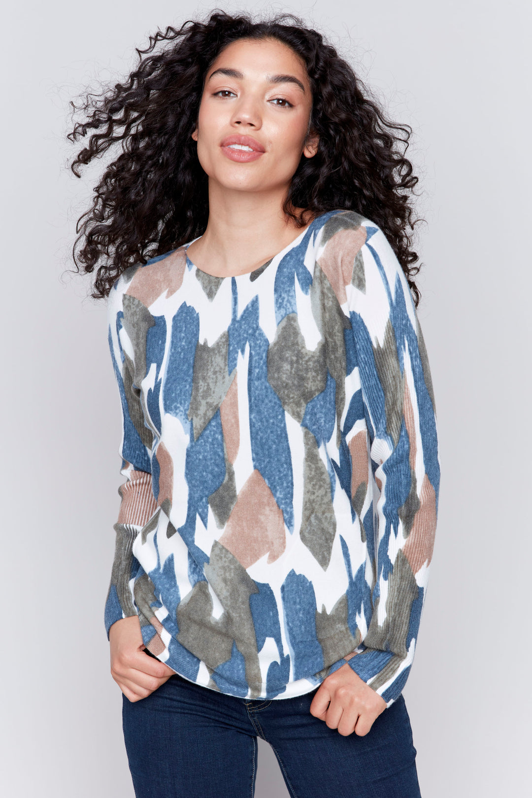 Charlie B Fall 2024 This Painted Camo Long Sleeve Top is made from plush knit fabric, giving you a comfortable and stylish look. 