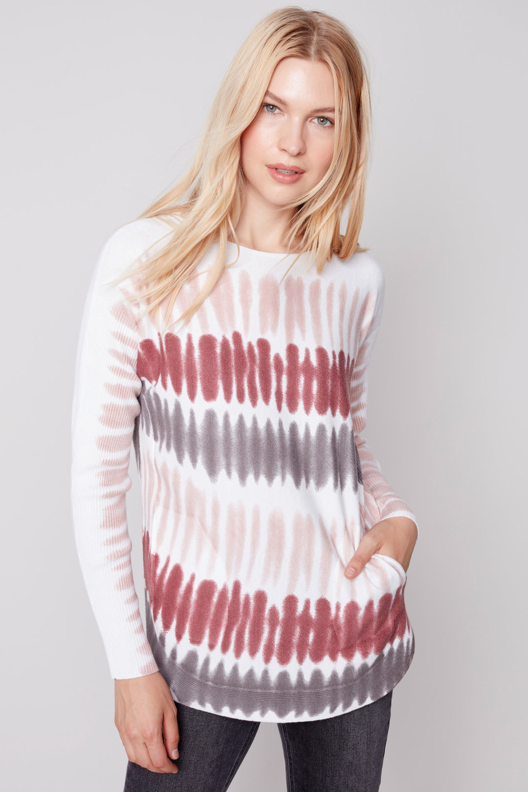 This Paint Stripes Long Sleeve Top is a gorgeous early fall feel sweater. Crafted using plush knit and featuring raspberry tones with pink highlights, this top is elevated with a lace-up cuff detail and pockets. Enjoy the comfort of a rounded hem and soft natural style with this statement piece.
