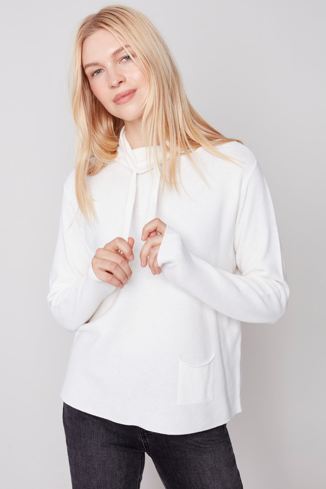 Introducing the Drawstring Neck Top! This luxurious solid ottoman cotton light sweater is designed to keep you warm and cozy without compromising on style. It features a funnel neckline and pocket detailing, adding a contemporary edge. Crafted from 100% cotton it's perfect for your fall and winter wardrobe.  Style and comfort, what more could you need?