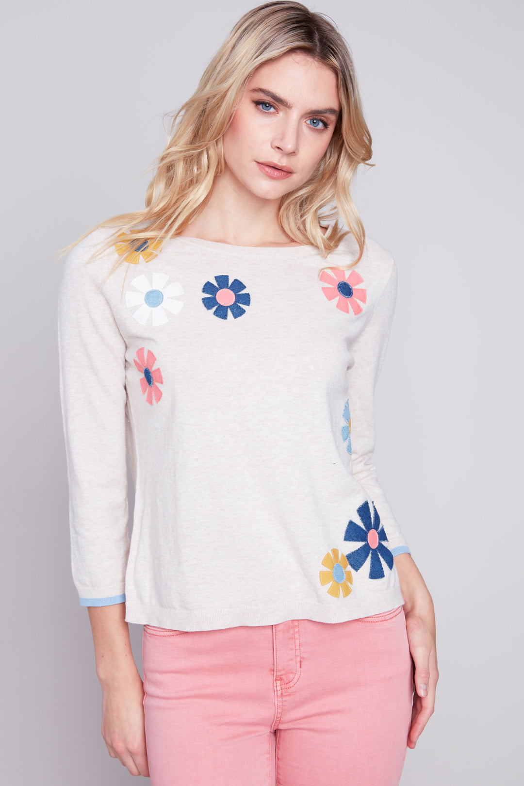 Made from lightweight cotton, this cute sweater top features 3/4 length sleeves, contrast cuffs and a charming collection of spring flowers! 