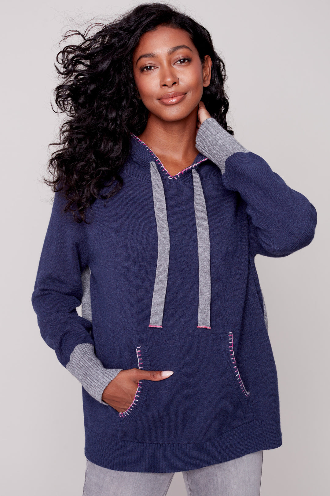It's made with a super plush knit for extra warmth and features a kangaroo hoodie with a blanket stitch detail for added style.